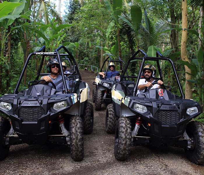 three people in ATV lining up for race in Bali jungle